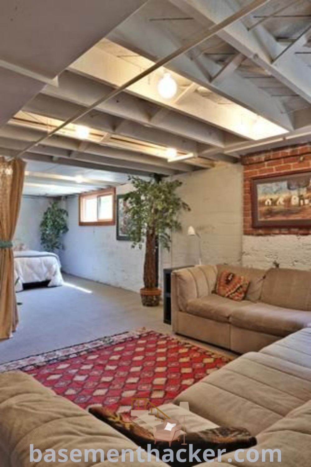 A stylish living room in a basement filled with furniture, a rug on a carpeted floor, showcasing innovative basement makeover ideas for a stunning revamp. This space combines comfort and functionality, ideal for families seeking budget-conscious solutions. Discover more decor tips at basementhacker.com.