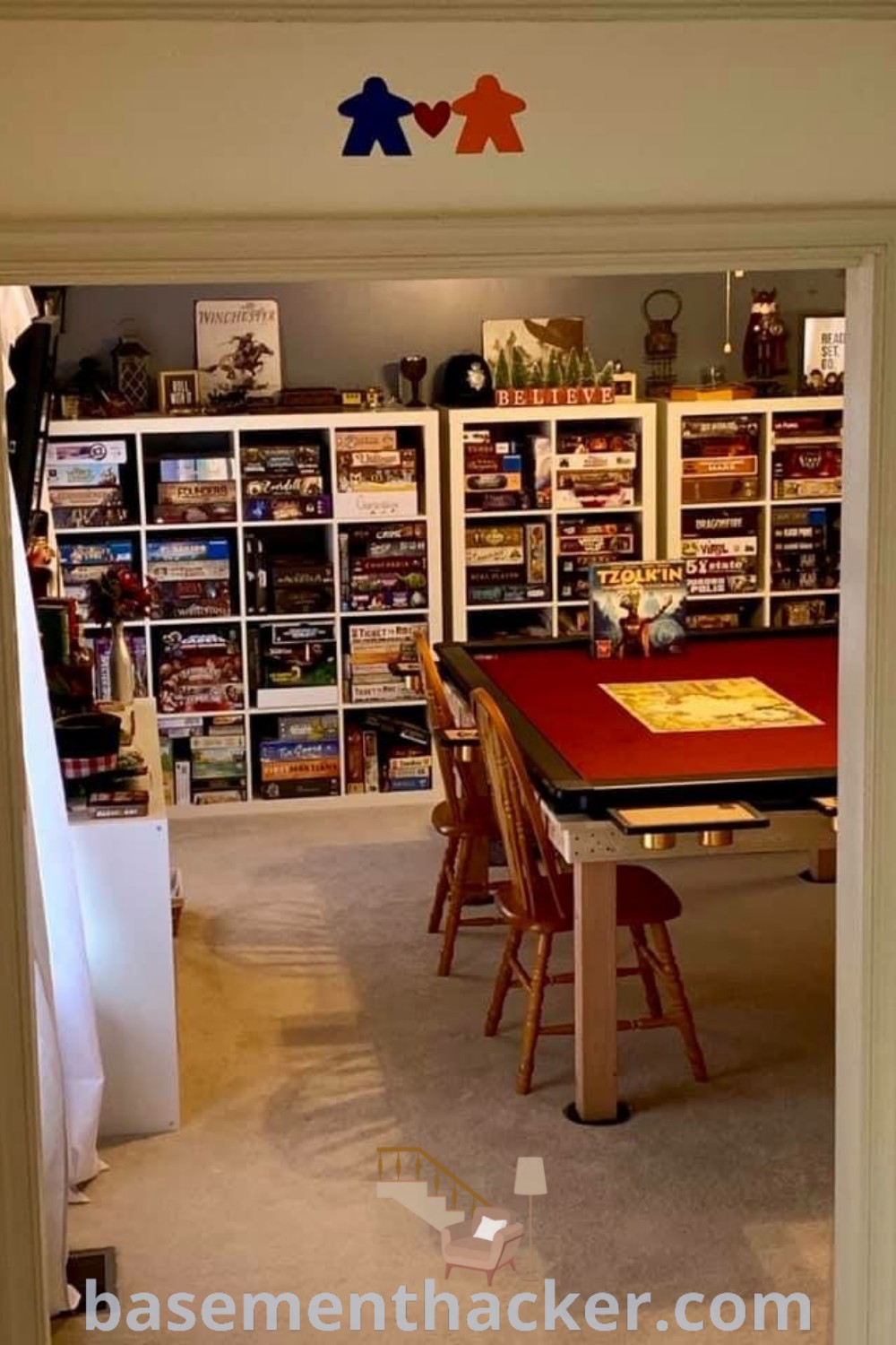 A cozy teenage hangout room with an open door leading to shelves filled with books and game tables, designed for board games and family gatherings. Ideal for innovative basement makeover ideas and stylish bonus space concepts, this room offers plenty of ideas to upgrade your space. Explore more designs at basementhacker.com.